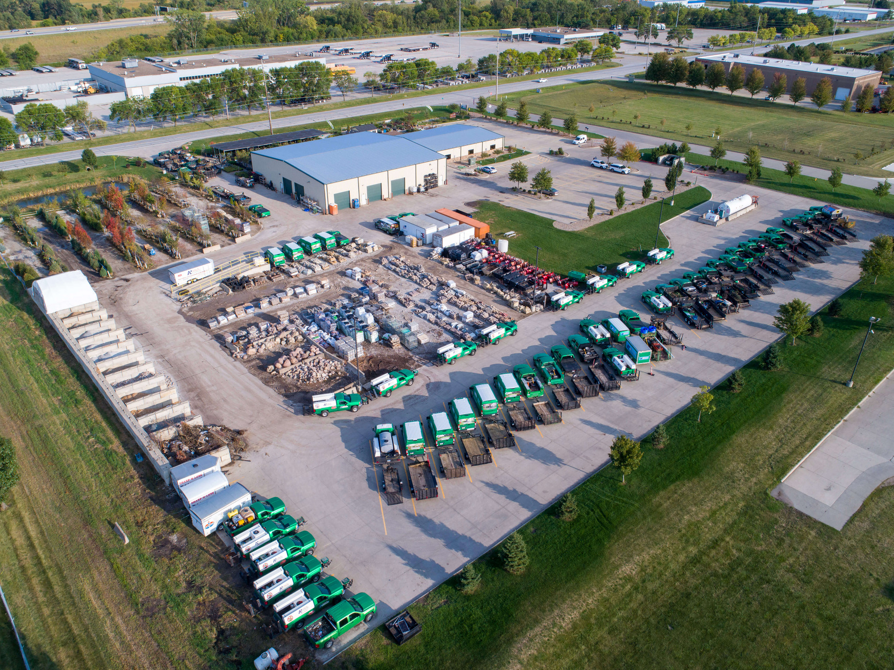 A+ Lawn & Landscape team with their fleet of branded vehicles